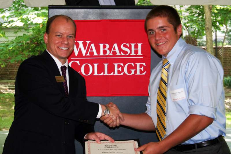 a man shaking hands with another man