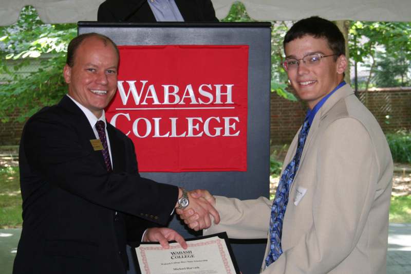 a man shaking hands with another man