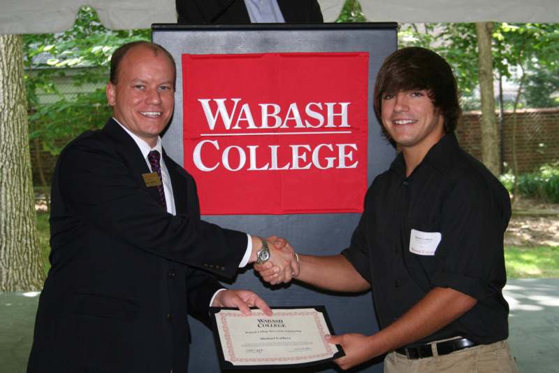 a man shaking hands with another man
