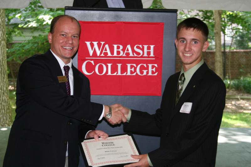 a man shaking hands with another man