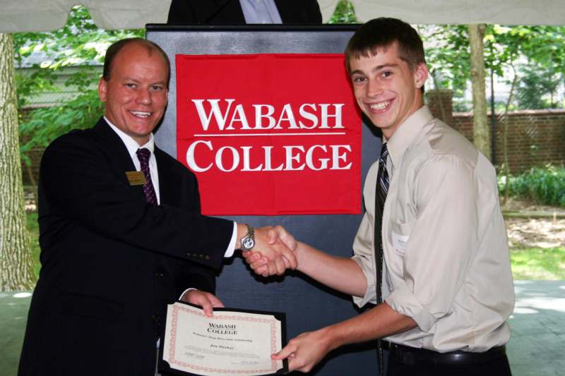 a man shaking hands with another man