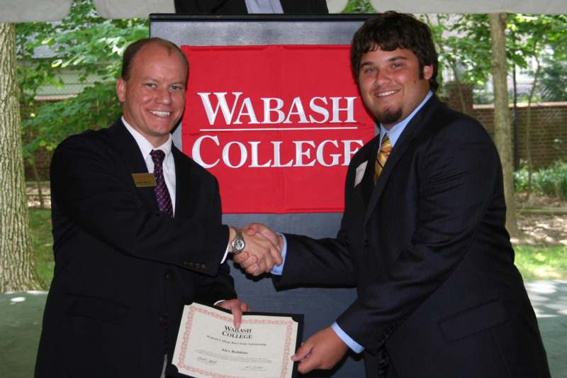 men shaking hands with a certificate