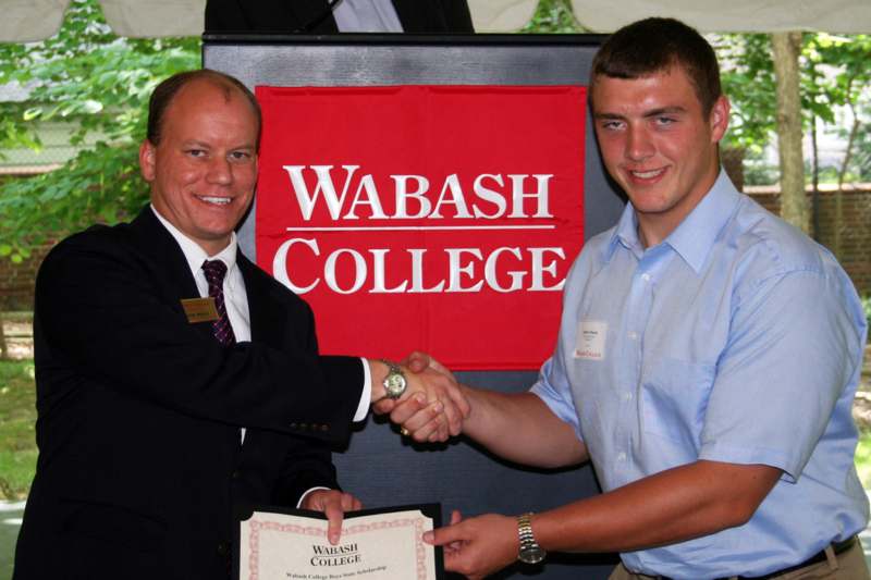 a man shaking hands with another man