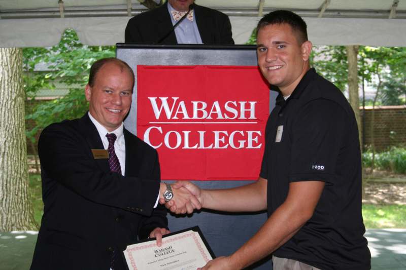 a man shaking hands with another man