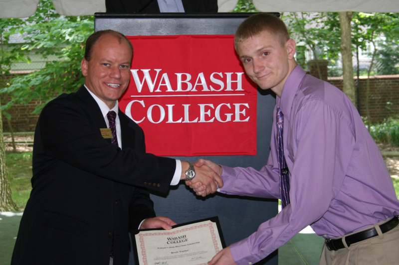 a man shaking hands with another man