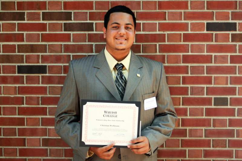 a man in a suit holding a certificate