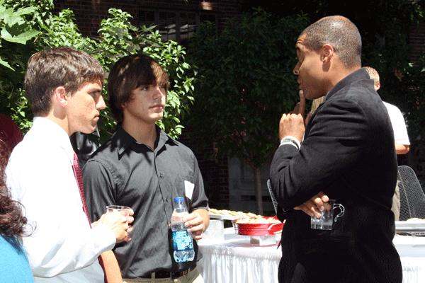 a group of men talking to each other