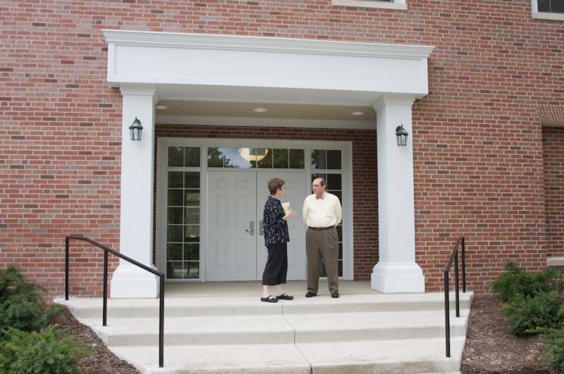 a man and woman standing outside of a building