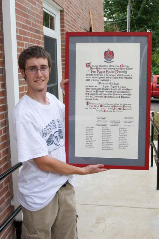 a man holding a framed certificate