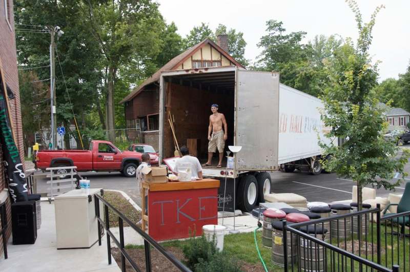 a man standing in the back of a truck