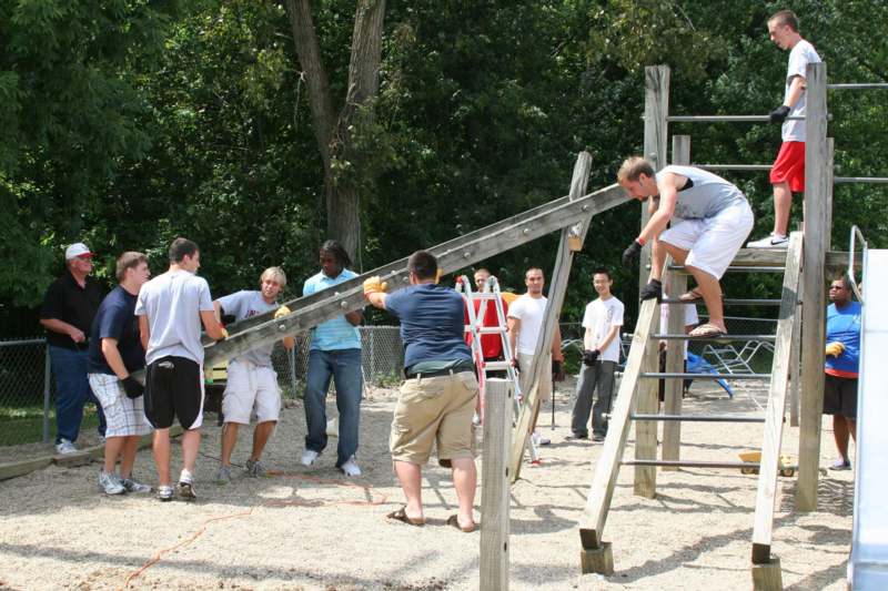 a group of people working on a playground