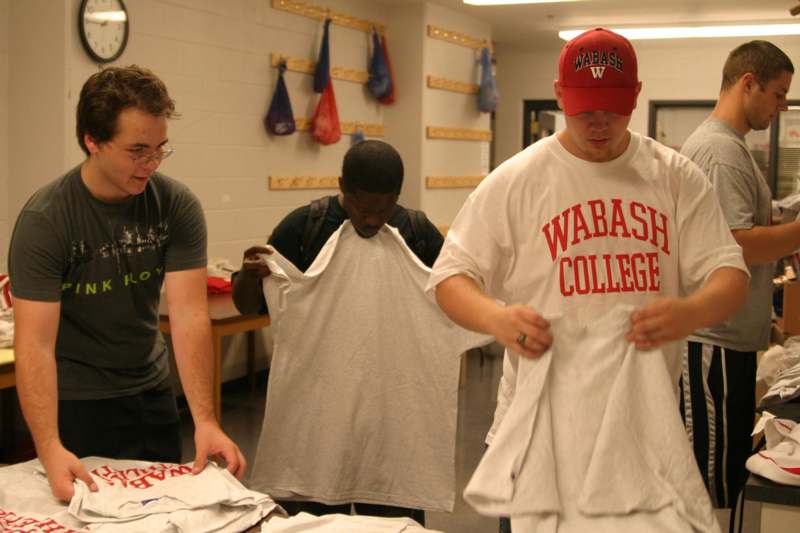 a group of men looking at t-shirts
