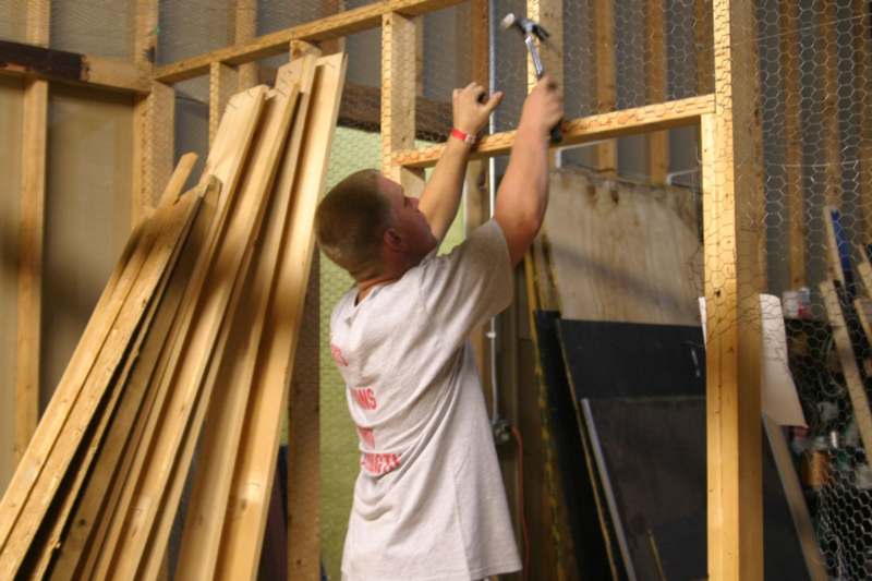 a man working on a wood frame