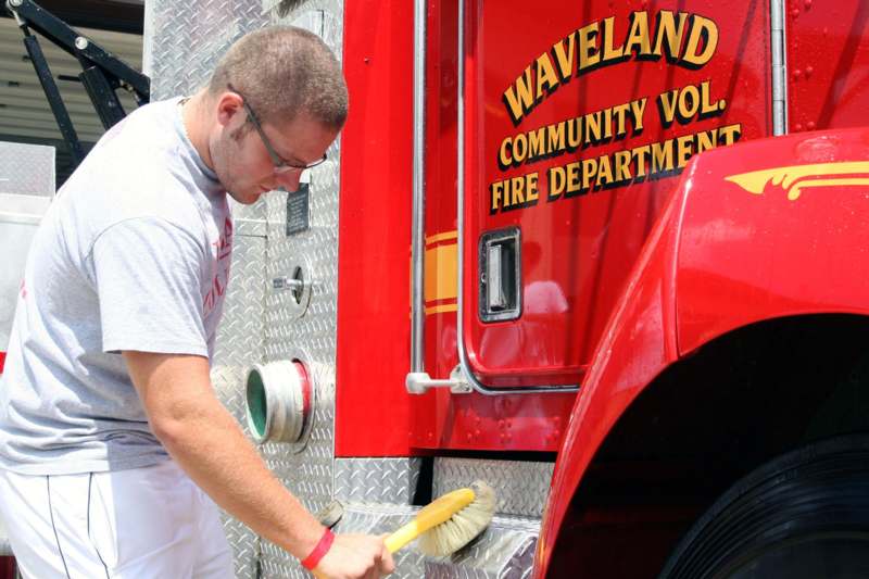 a man cleaning a fire truck