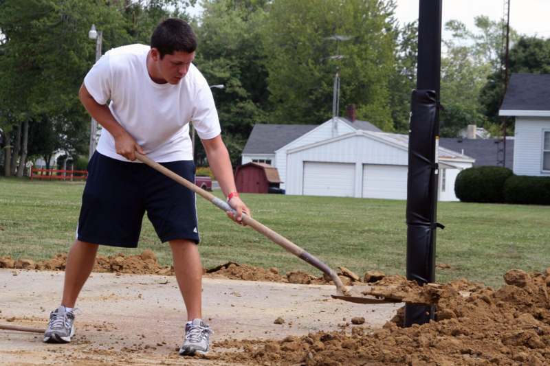 a man digging a hole in the ground