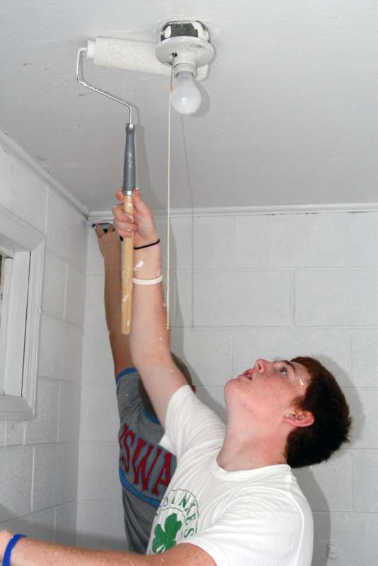 a man painting a light bulb