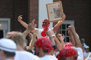 a man with red bandana holding a picture of a man