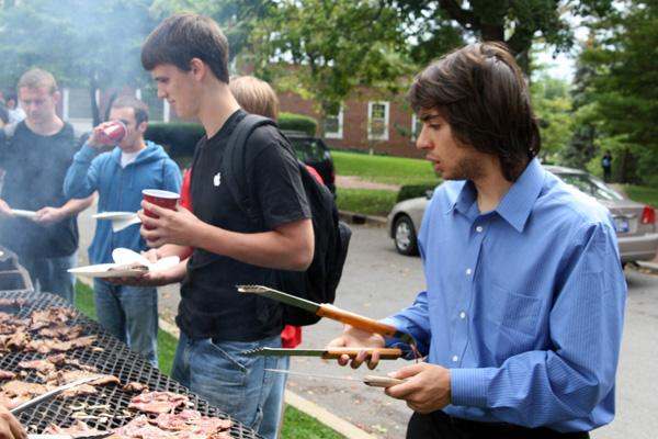 a group of men grilling meat