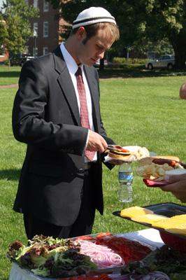 a man in a suit eating a sandwich