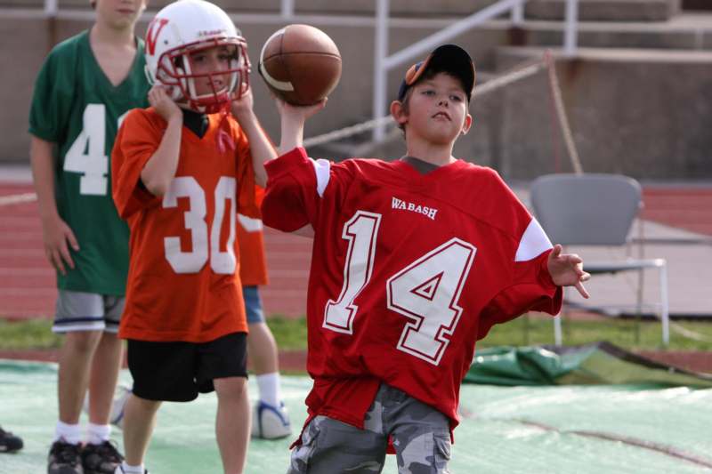 a boy throwing a football