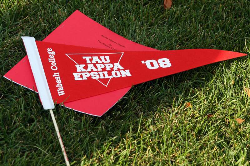 a red paper airplane on grass