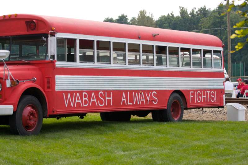 a red bus parked on grass