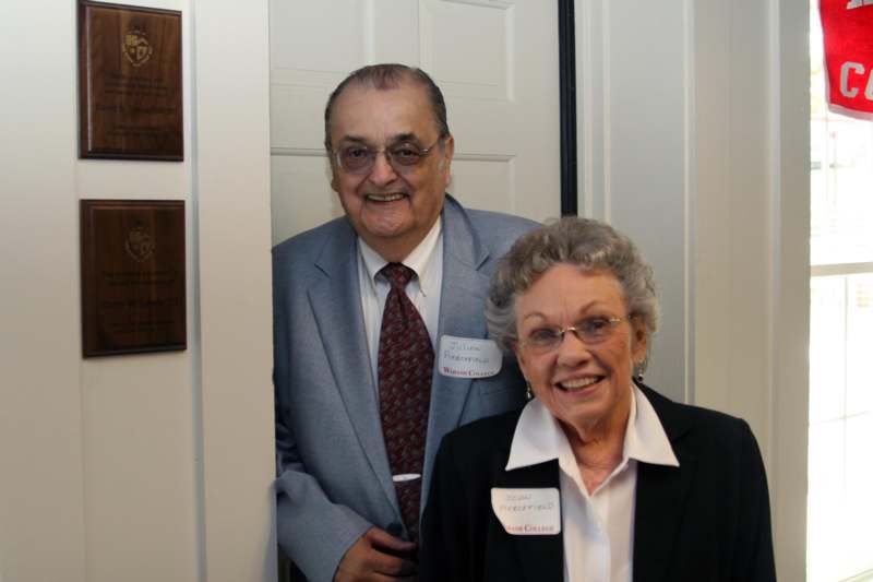 a man and woman standing in front of a door