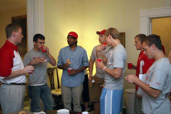 a group of men drinking and talking