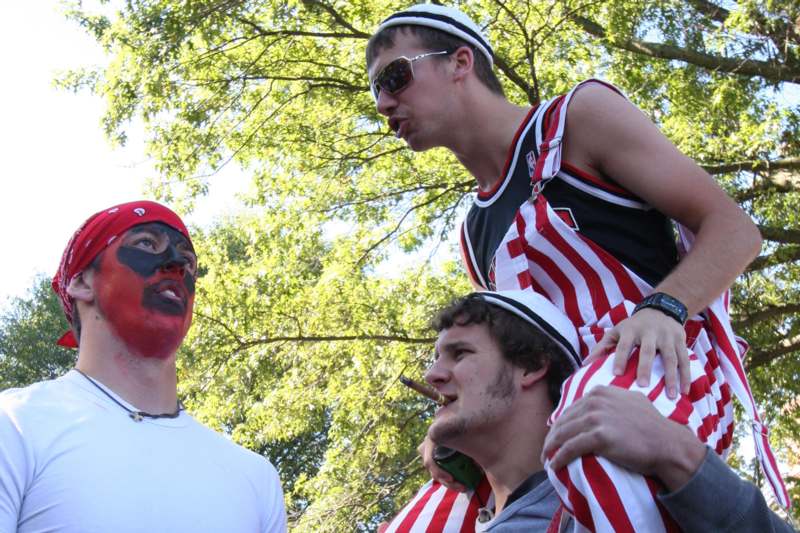 a group of men with face paint on their shoulders