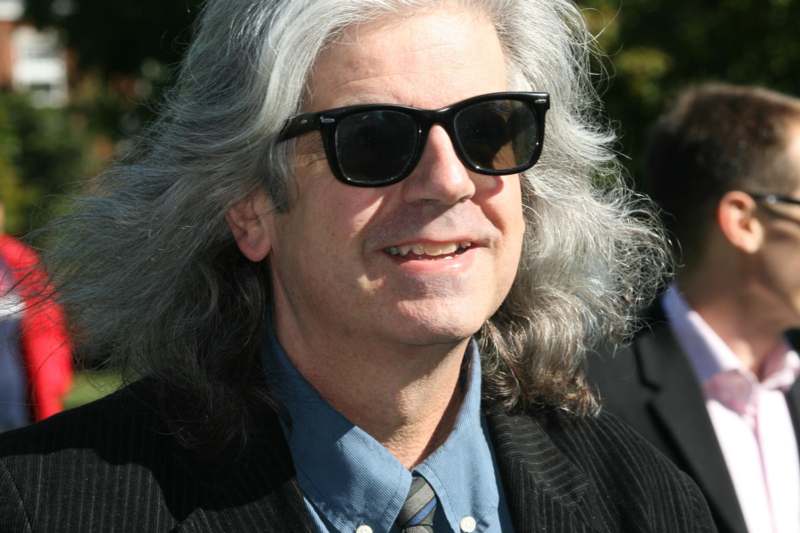 a man with long hair wearing sunglasses