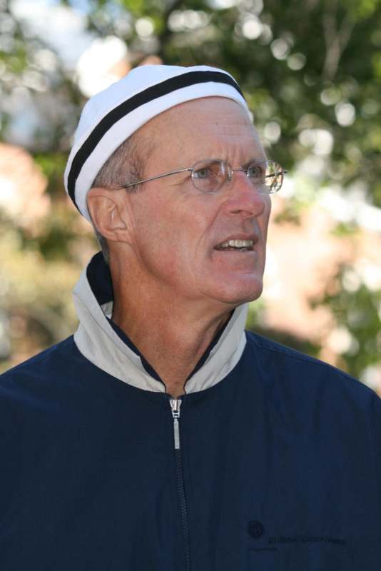 a man wearing a white hat and blue jacket