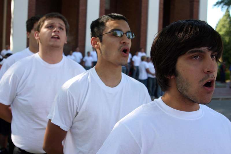 a group of men in white shirts