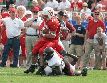 a football player being tackled by a crowd