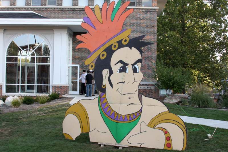 a cardboard cut out of a cartoon character in front of a house