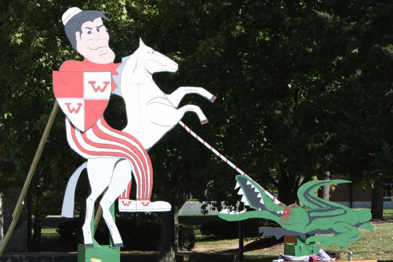 a large wooden statue of a knight riding a horse and alligator