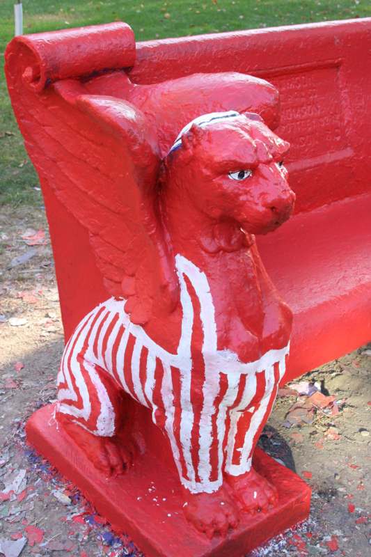 a red statue of a winged animal