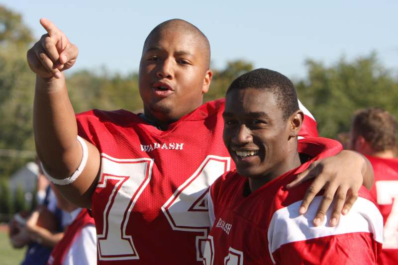 a group of football players in red jerseys