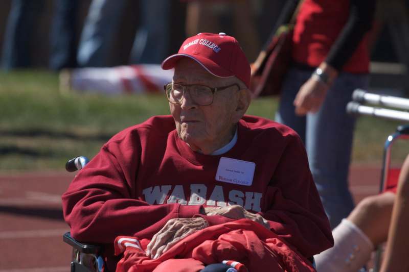 an old man in a red hat and sweatshirt