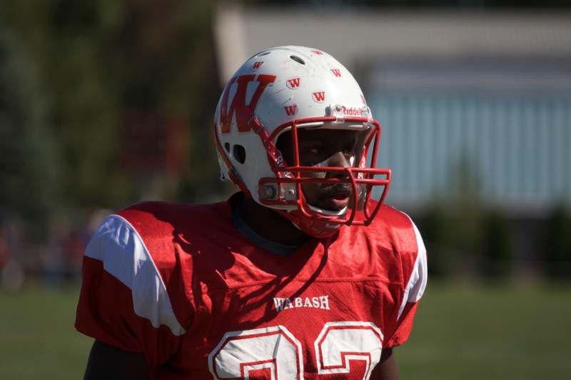 a football player wearing a red and white football uniform