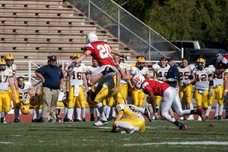 a football player jumping over a football player