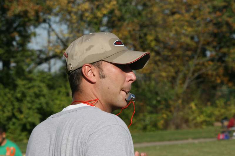 a man wearing a hat and whistle