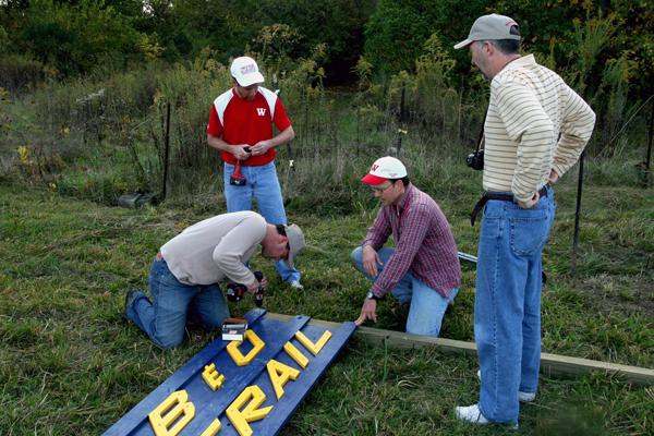 a group of men working on a sign