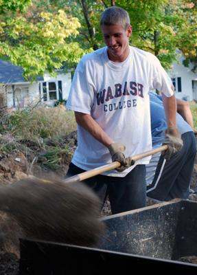 a man digging in a wheelbarrow