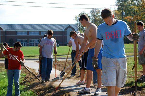 a group of young men digging in the dirt