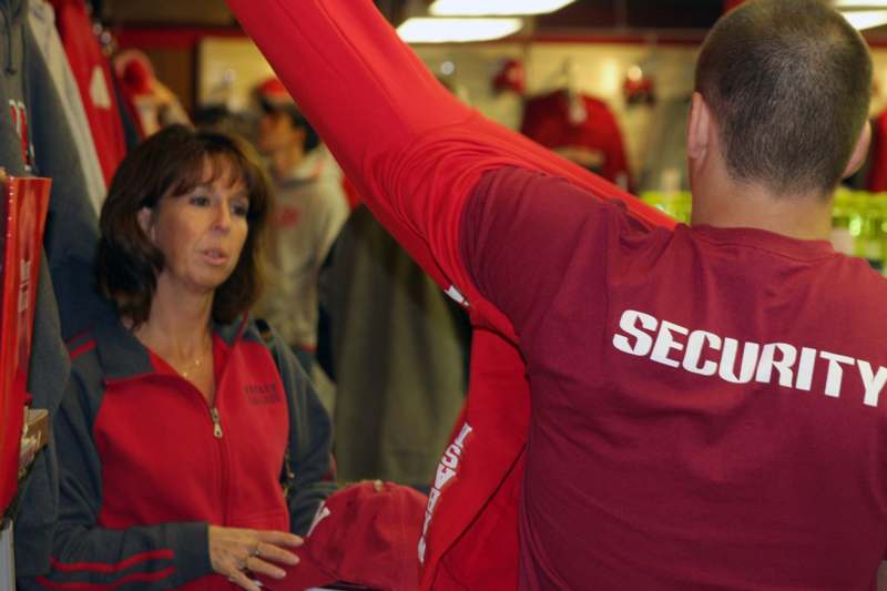 a man in red shirt with a woman in the background