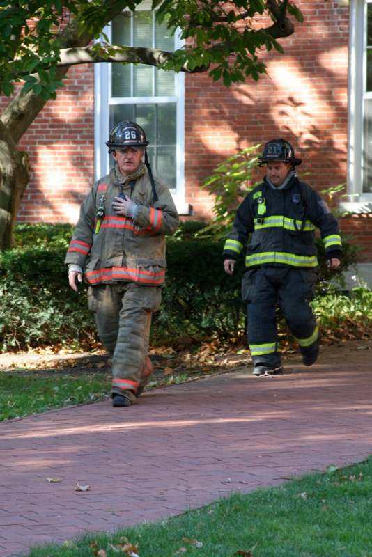 a firefighter walking on a brick path