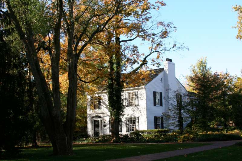 a white house with trees in the background
