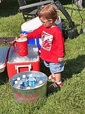 a child pouring water into a cup