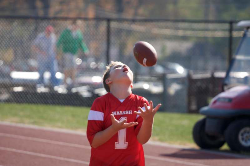 a boy catching a football