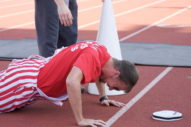 a man in a red shirt on a track